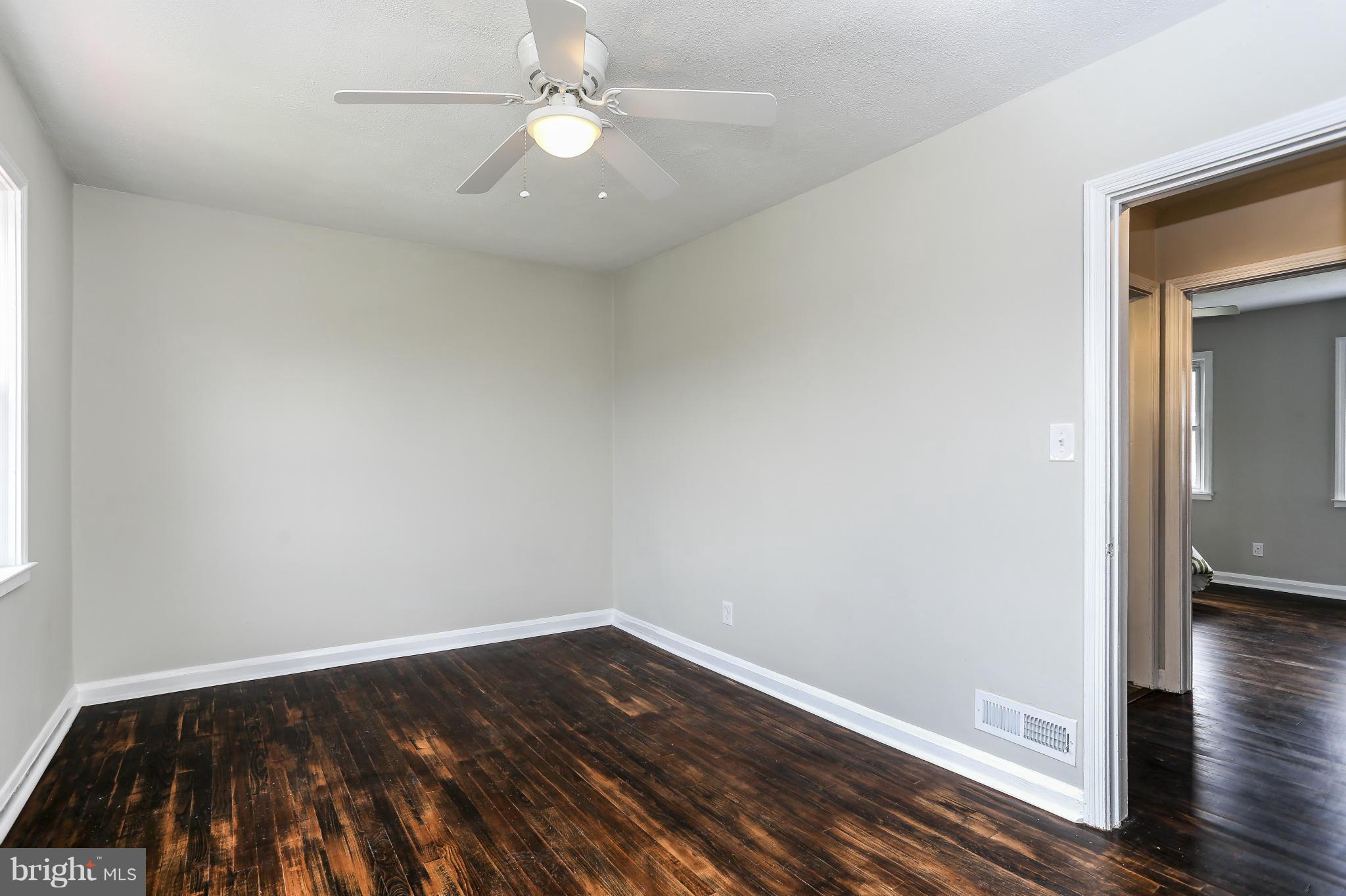 6923 Belclare Road Baltimore, MD 21222 - Photo 20 of 23 wooden floor in an empty room
