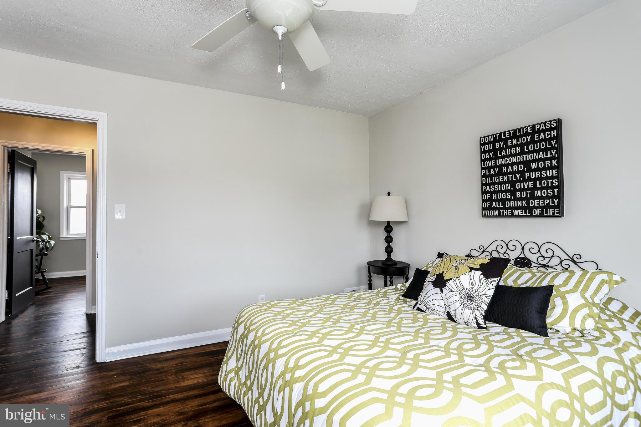 6923 Belclare Road Baltimore, MD 21222 - Photo 4 of 23 a bedroom with bed and wooden floor