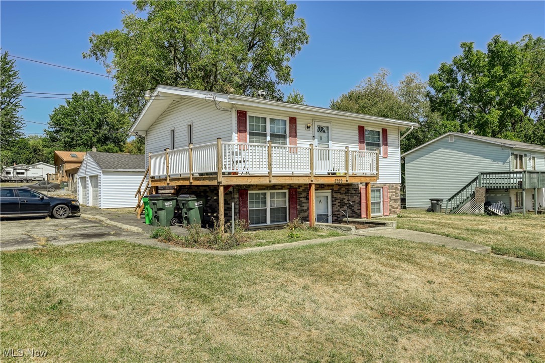 2359 Sanitarium Road Lakemore, OH 44250 - Photo 5 of 29 View of front of home with an outdoor structure, a front yard, and a deck