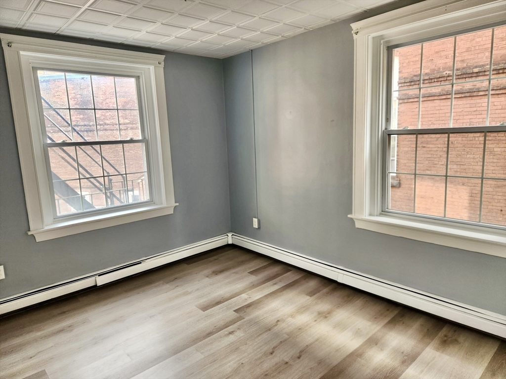 15 North Main Street, Unit 20 Attleboro, MA 02703 - Photo 1 of 6 an empty room with wooden floor and windows