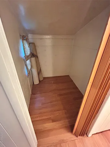 a bedroom with a bed and a mirror