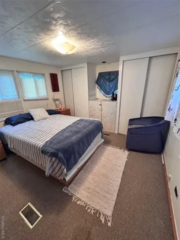 a backyard of a house with lots of green space and fountain