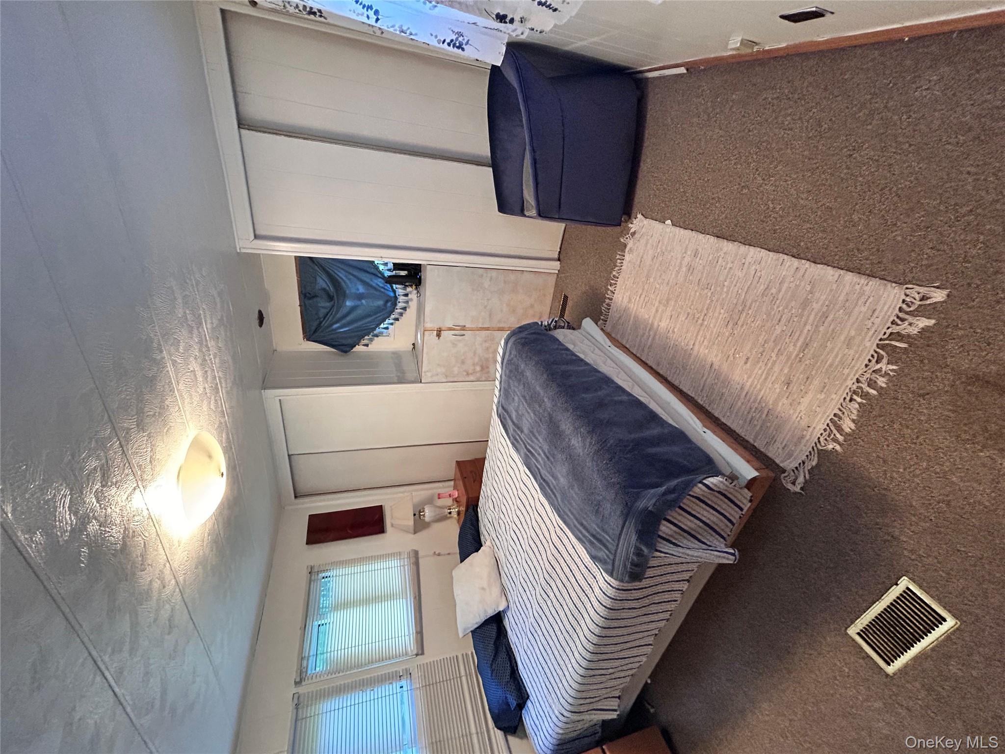 98 Buff Road Cochecton, NY 12726 - Photo 9 of 13 a bedroom with a bed and a mirror