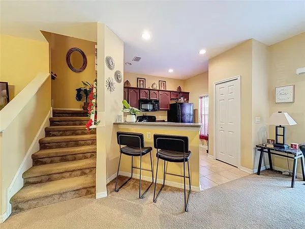 a view of kitchen with furniture and staircase