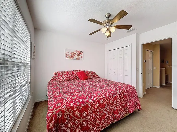 a bedroom with a bed and ceiling fan