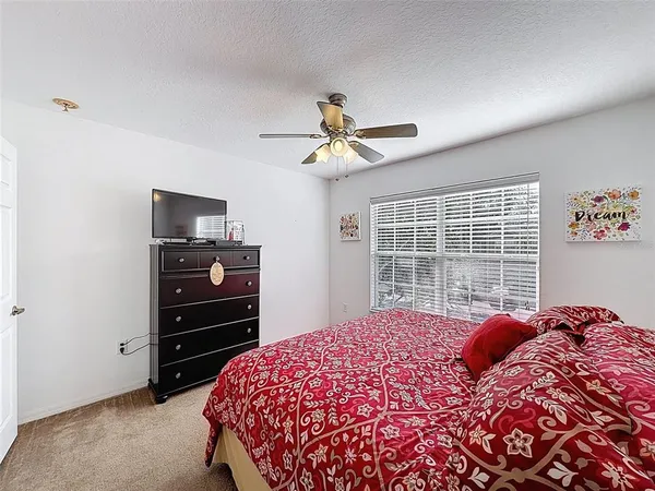 a bedroom with a bed dresser and a window