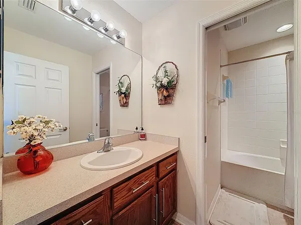 a bathroom with a sink vanity granite and a mirror