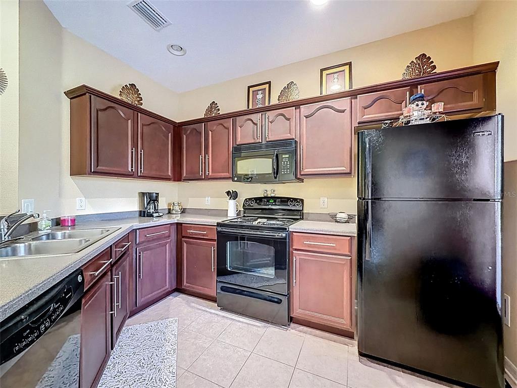 11807 Castine Street New Port Richey, FL 34654 - Photo 5 of 41 a kitchen with stainless steel appliances granite countertop a refrigerator stove and sink