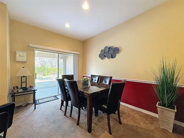 a view of a dining room with furniture and a potted plant