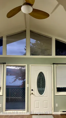 a view of a room with wooden floor and windows