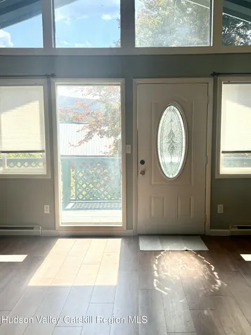 a view of a room with wooden floor and windows