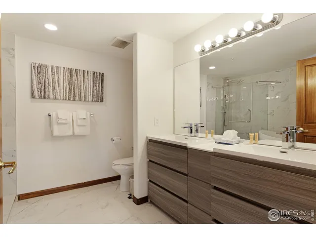 a bathroom with a toilet a sink and shower
