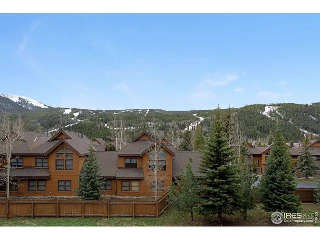 a living room with fireplace furniture and a large window