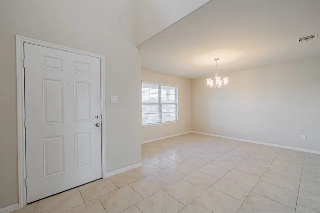 an empty room with fan and windows