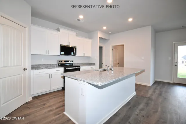 a kitchen with a sink stove and microwave