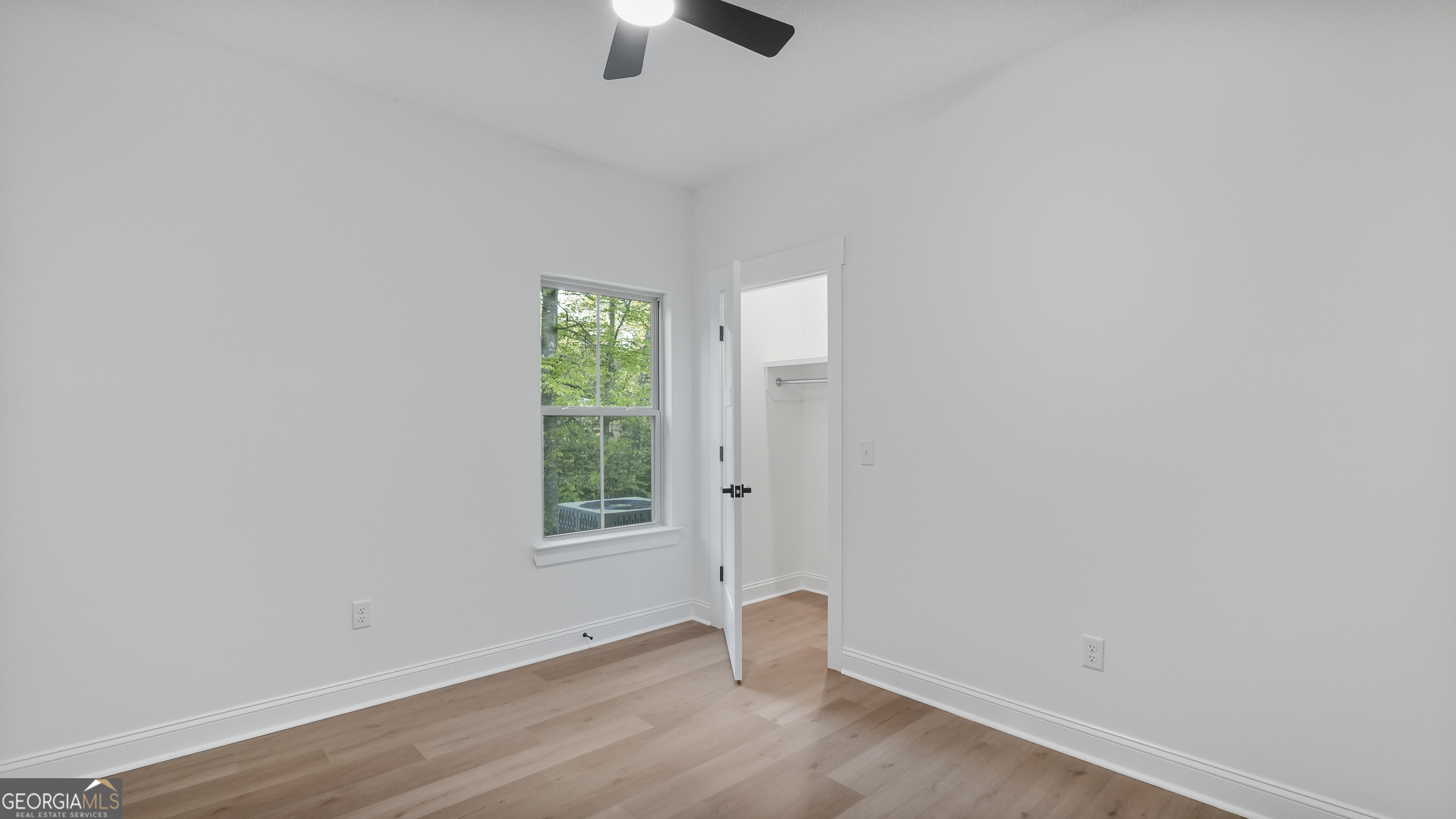 150 Lakeview Drive Jesup, GA 31545 - Photo 30 of 34 an empty room with wooden floor and windows