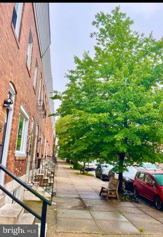 a view of a cars park in front of a building
