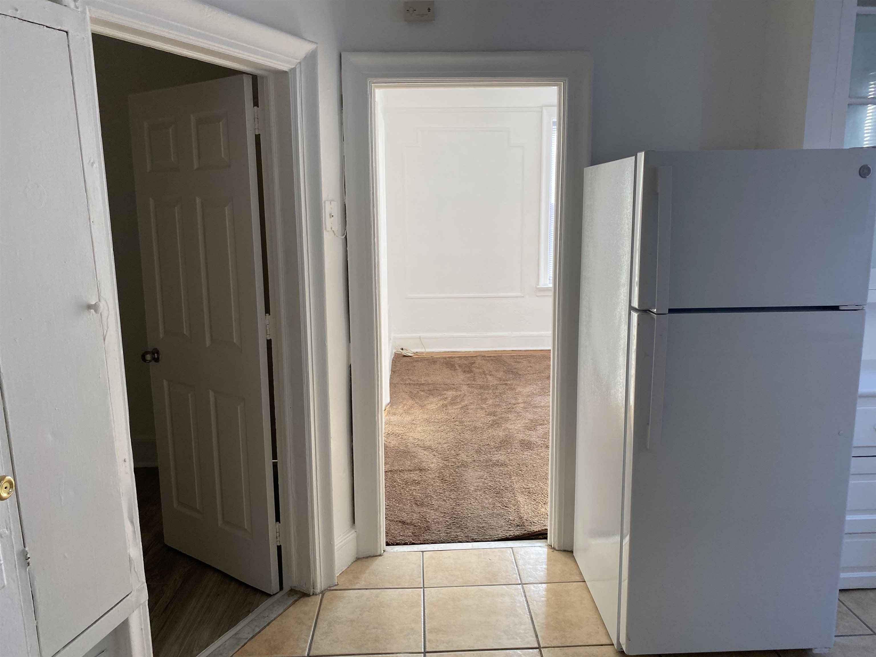 19 Fox Place, Unit 3 Jersey City, NJ 07306 - Photo 13 of 18 a view of a refrigerator in kitchen and an empty room