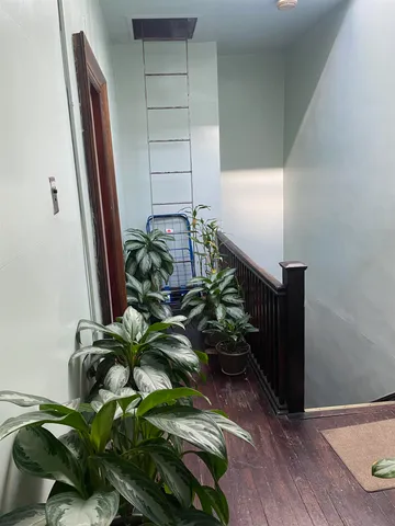 a vase of flowers sitting on a wooden floor