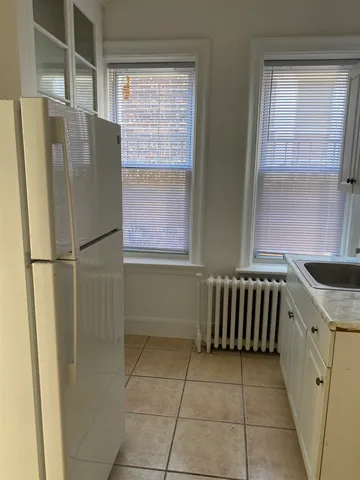 a kitchen with a refrigerator and a sink