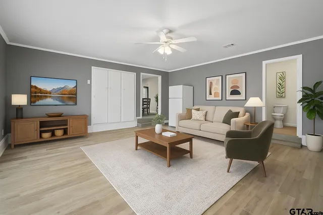 a living room with furniture and a flat screen tv