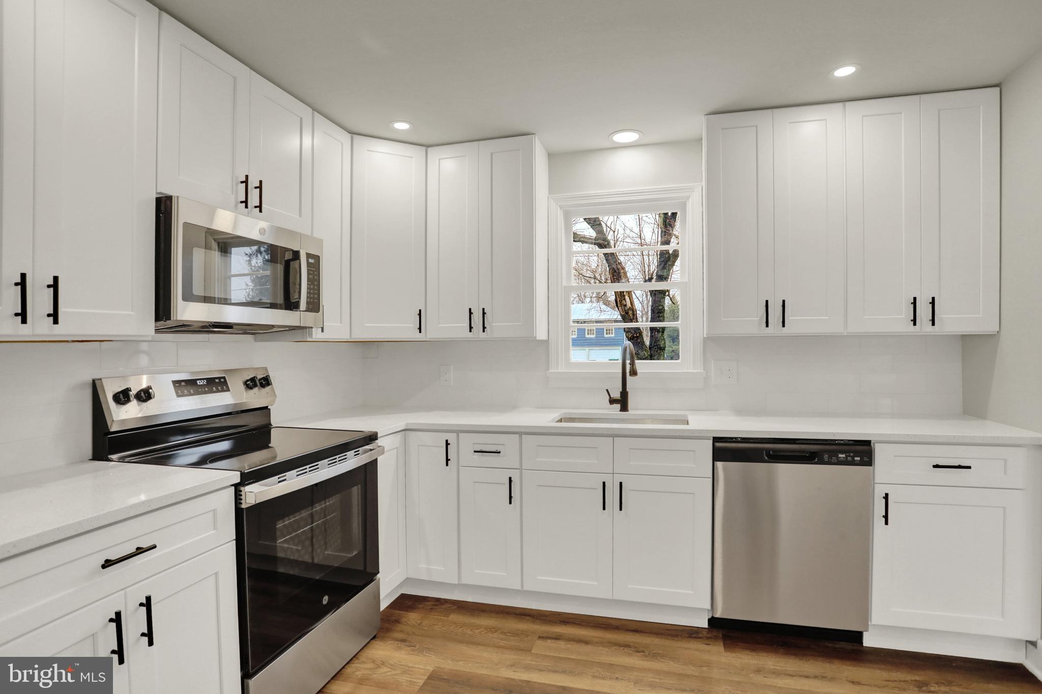 311 Pine Road Mount Holly Springs, PA 17065 - Photo 11 of 44 a kitchen with appliances a sink and cabinets