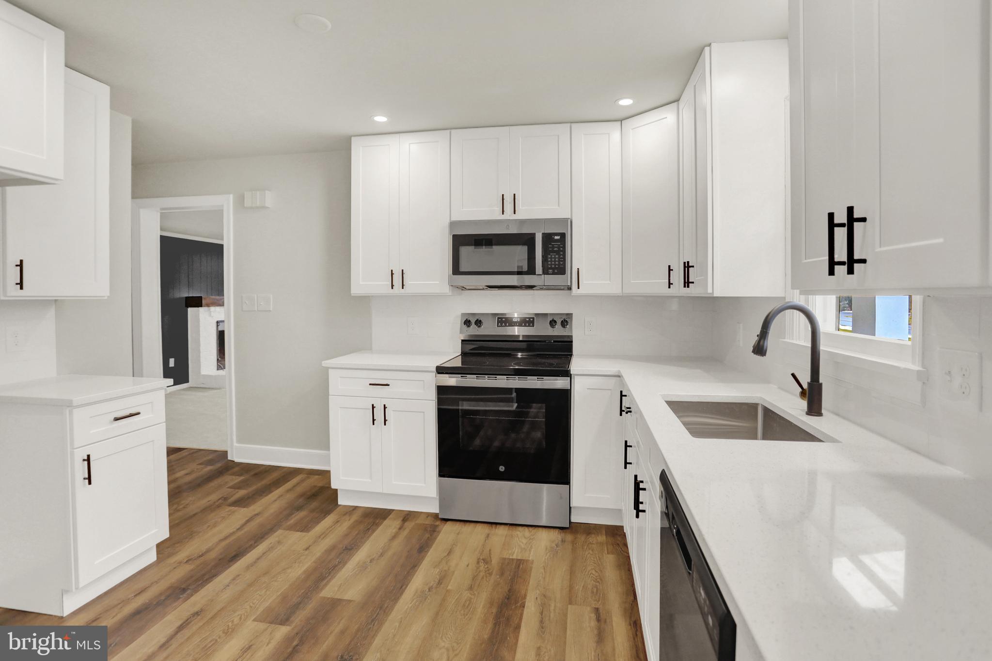 311 Pine Road Mount Holly Springs, PA 17065 - Photo 12 of 44 a kitchen with granite countertop a sink stove and refrigerator