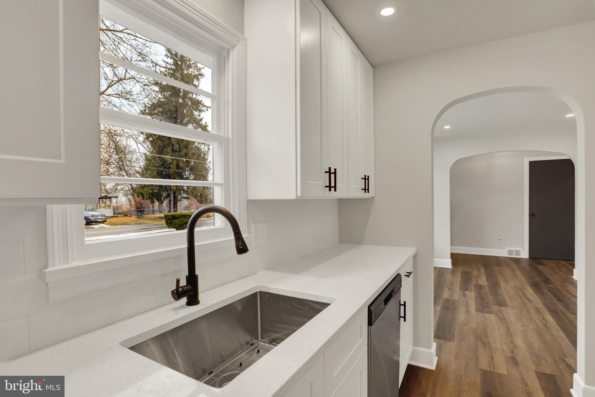 311 Pine Road Mount Holly Springs, PA 17065 - Photo 14 of 44 a kitchen with a sink a counter and a dining table