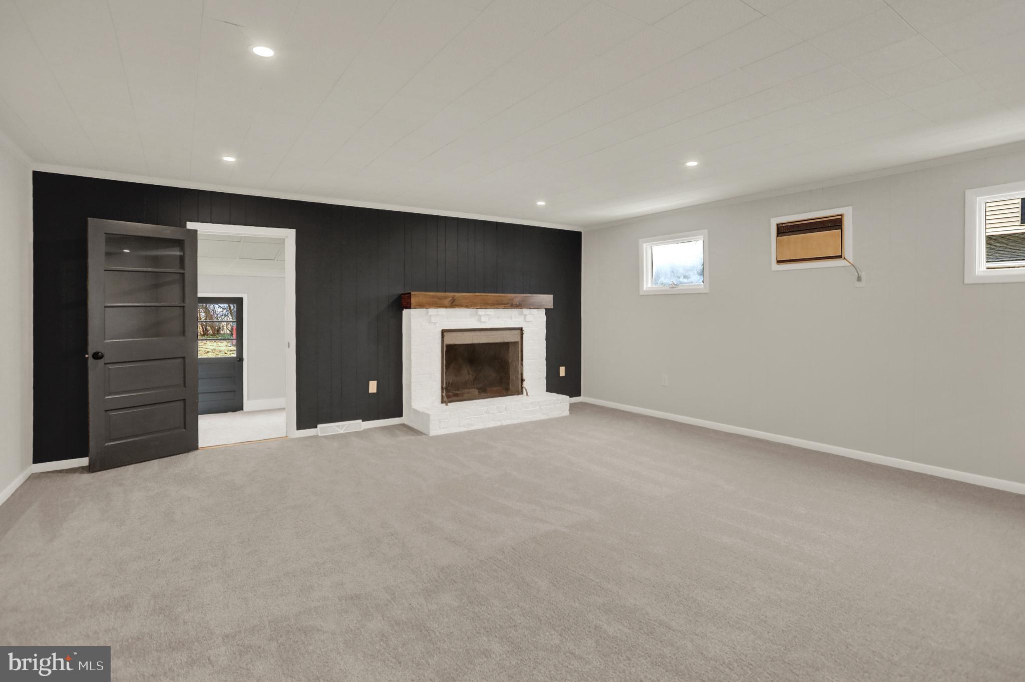 311 Pine Road Mount Holly Springs, PA 17065 - Photo 5 of 44 a view of an empty room with a fireplace and a window