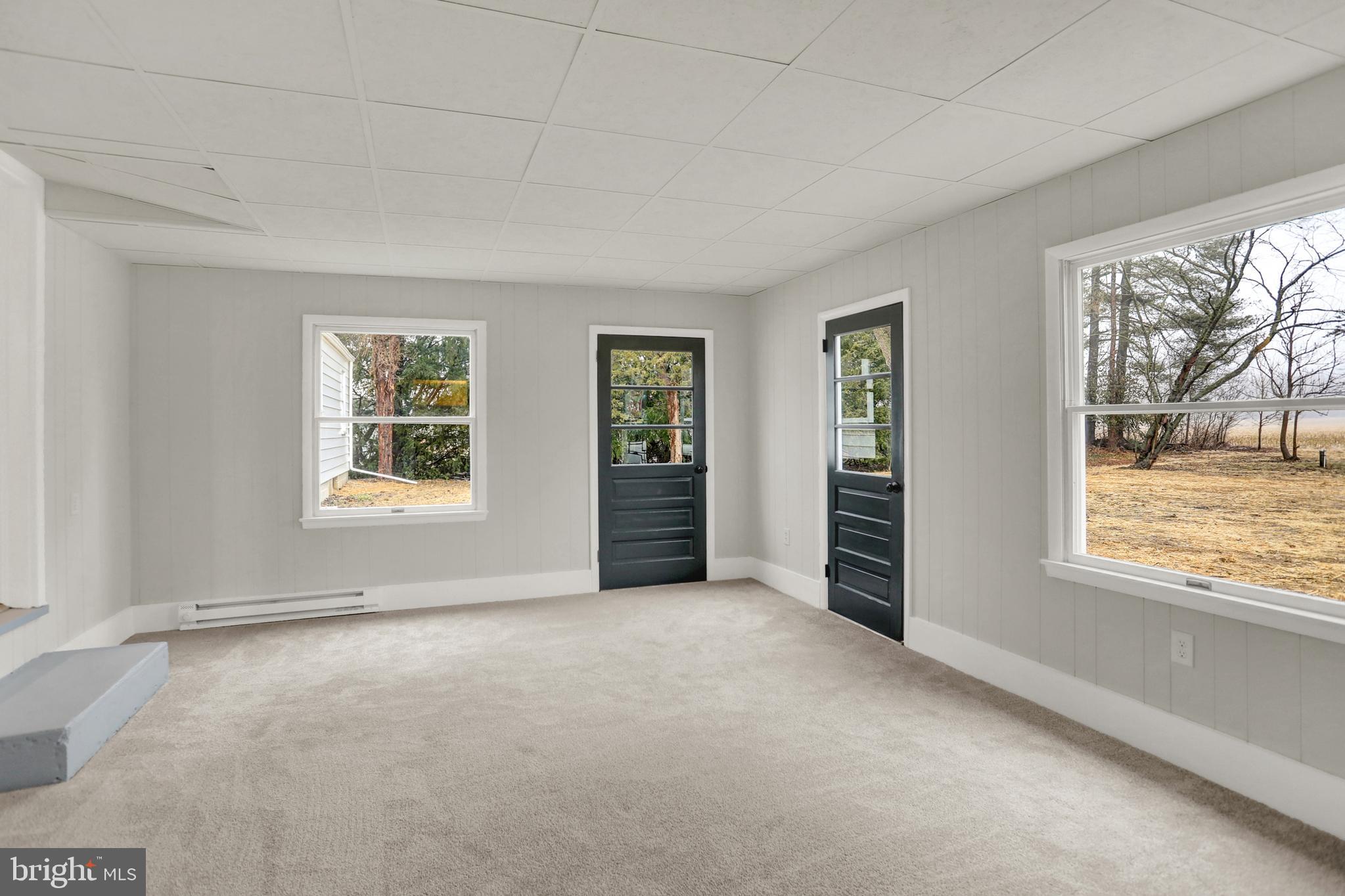 311 Pine Road Mount Holly Springs, PA 17065 - Photo 8 of 44 an empty room with windows lake and mountain view