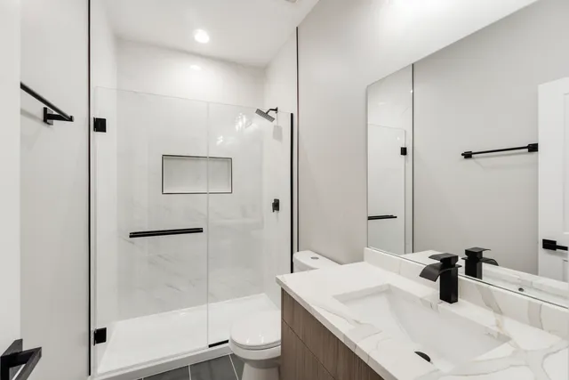 a bathroom with a sink toilet and shower