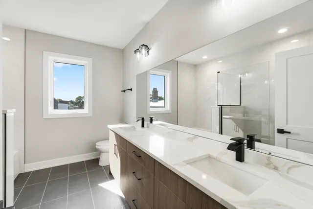 a bathroom with a sink double vanity and a mirror