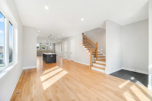 a view of kitchen and hall with wooden floor