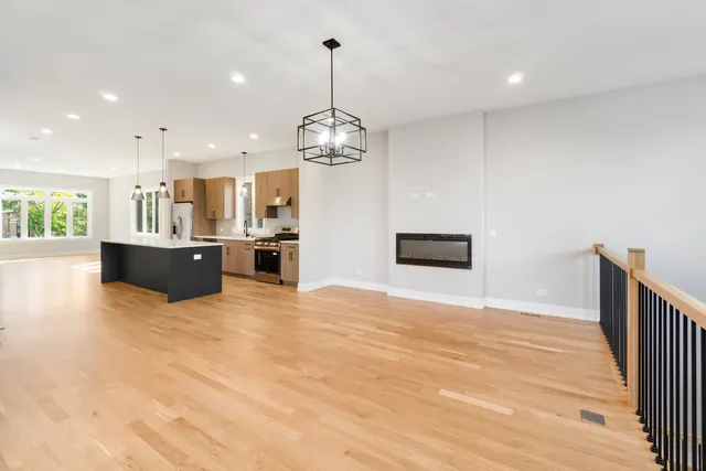 a view of a kitchen with a stove cabinets and a floor to ceiling window
