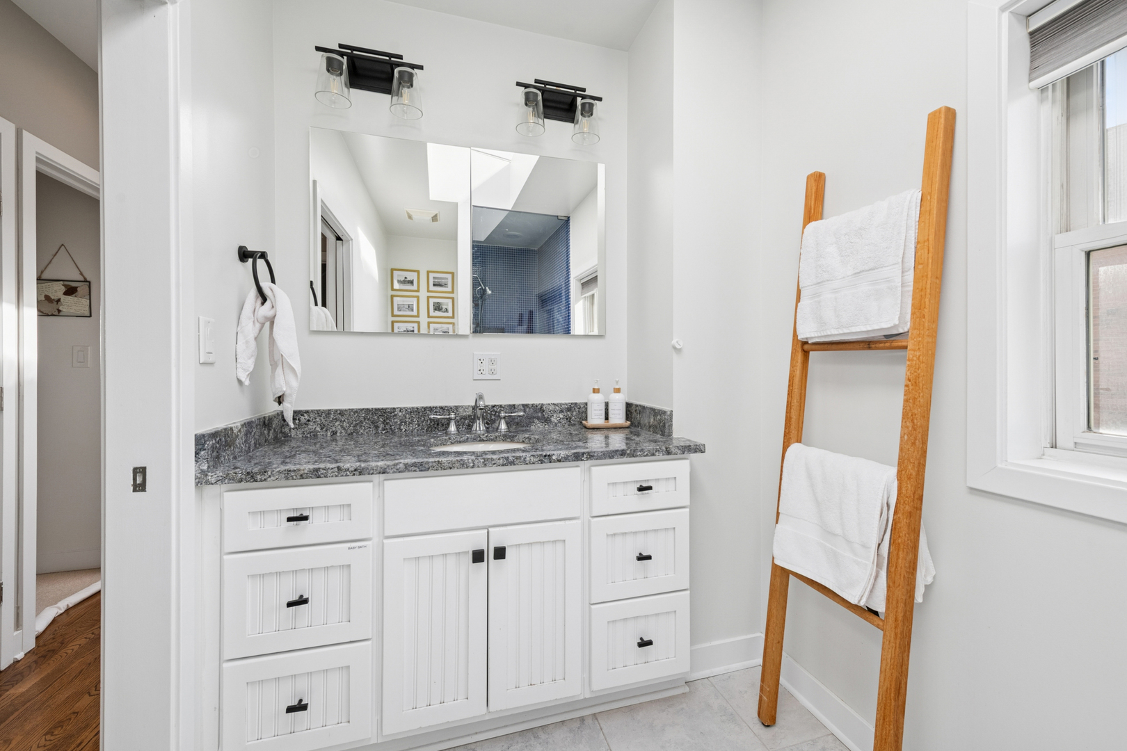 1809 West Melrose Street Chicago, IL 60657 - Photo 11 of 25 a bathroom with a granite countertop sink and a mirror