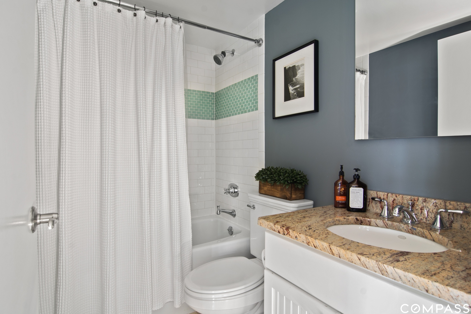 1809 West Melrose Street Chicago, IL 60657 - Photo 20 of 25 a bathroom with a granite countertop sink and a mirror