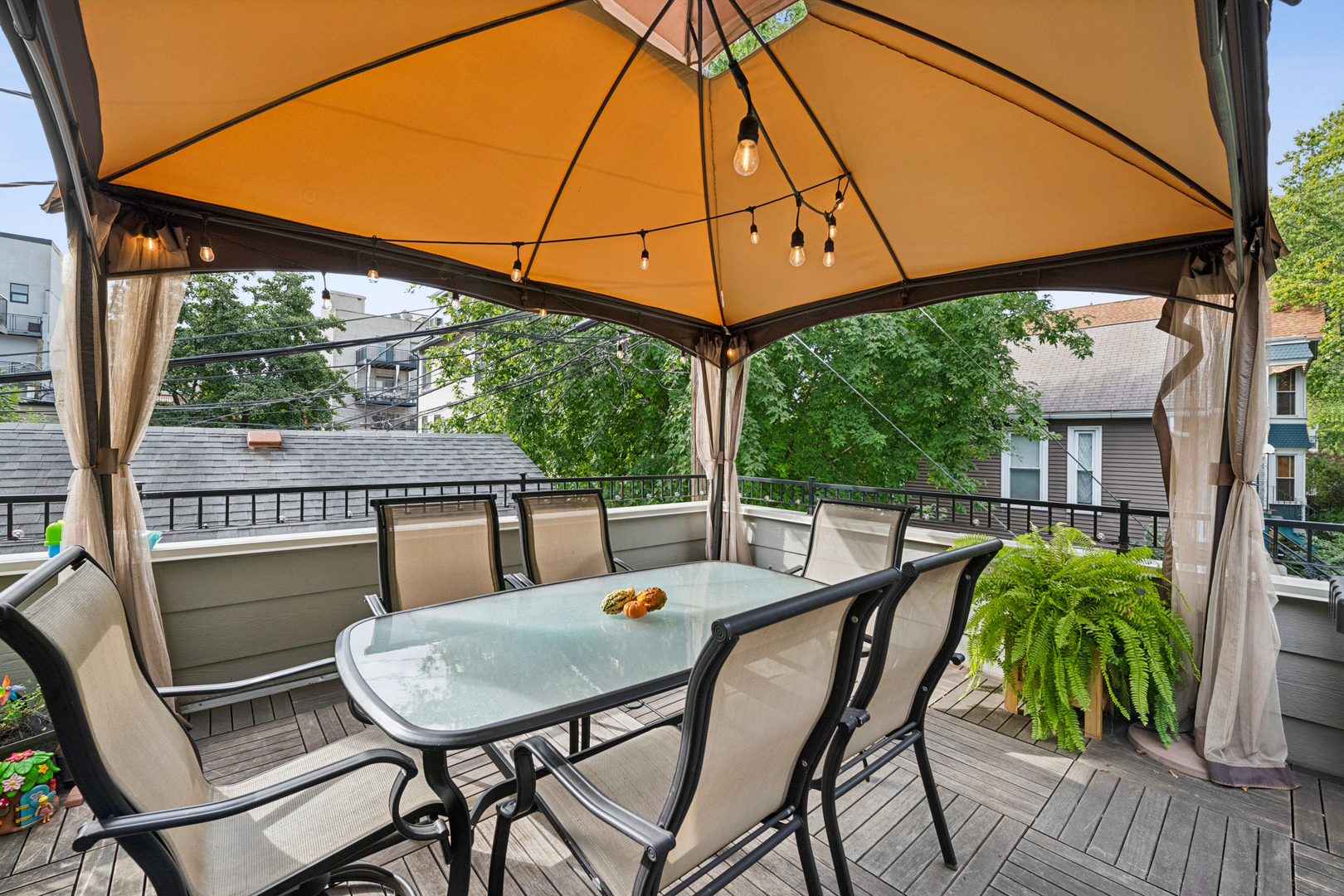 1809 West Melrose Street Chicago, IL 60657 - Photo 24 of 25 a view of a patio with table and chairs under an umbrella with a small yard