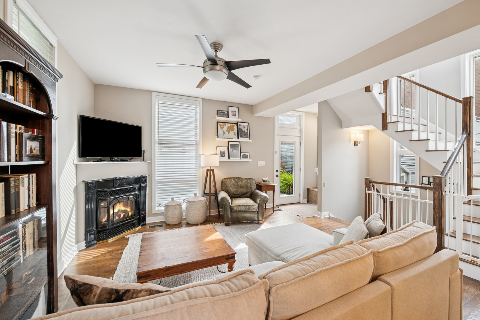 1809 West Melrose Street Chicago, IL 60657 - Photo 4 of 25 a living room with furniture a fireplace and a flat screen tv