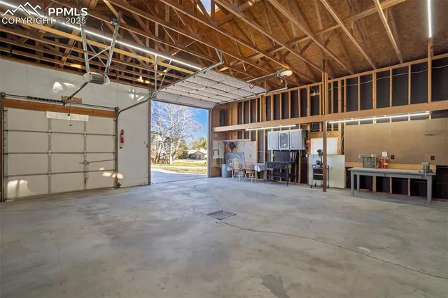 a view of a garage with wooden table and chairs