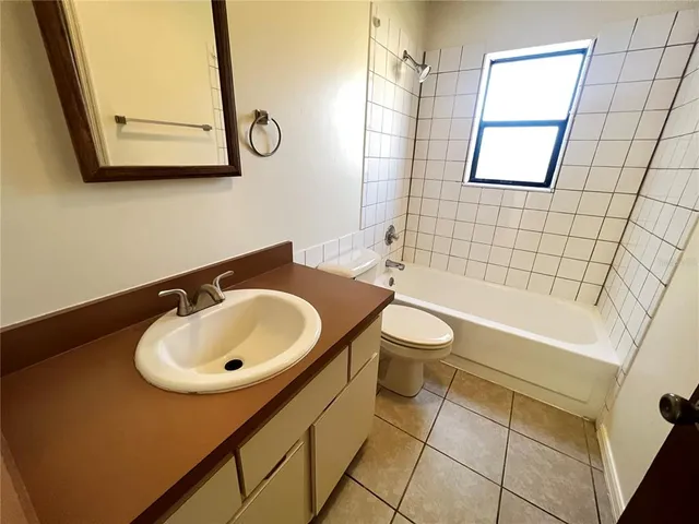 a bathroom with a sink a toilet and bathtub
