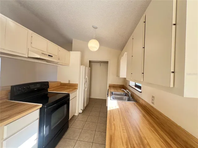 a kitchen that has a sink and a stove