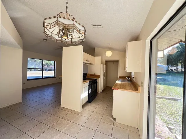 a view of a room with a dining table & chairs