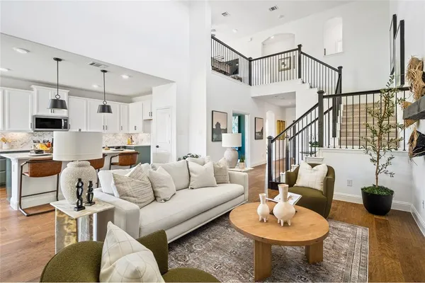 a living room with furniture a flat screen tv and a large window