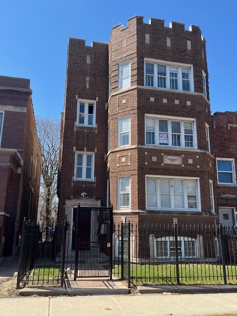 a front view of a residential apartment building with a yard