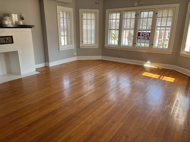 7804 South Burnham Avenue, Unit 2 Chicago, IL 60649 - Photo 2 of 9 wooden floor in an empty room with a window
