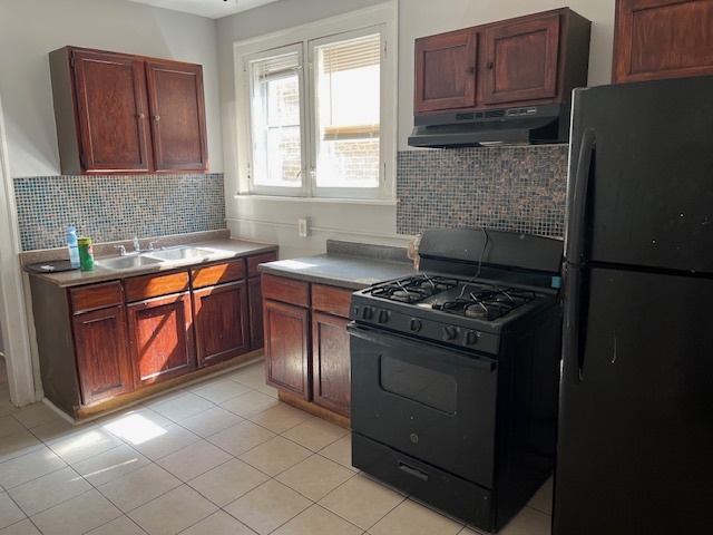 7804 South Burnham Avenue, Unit 2 Chicago, IL 60649 - Photo 8 of 9 a kitchen with stainless steel appliances granite countertop a stove a refrigerator and a sink