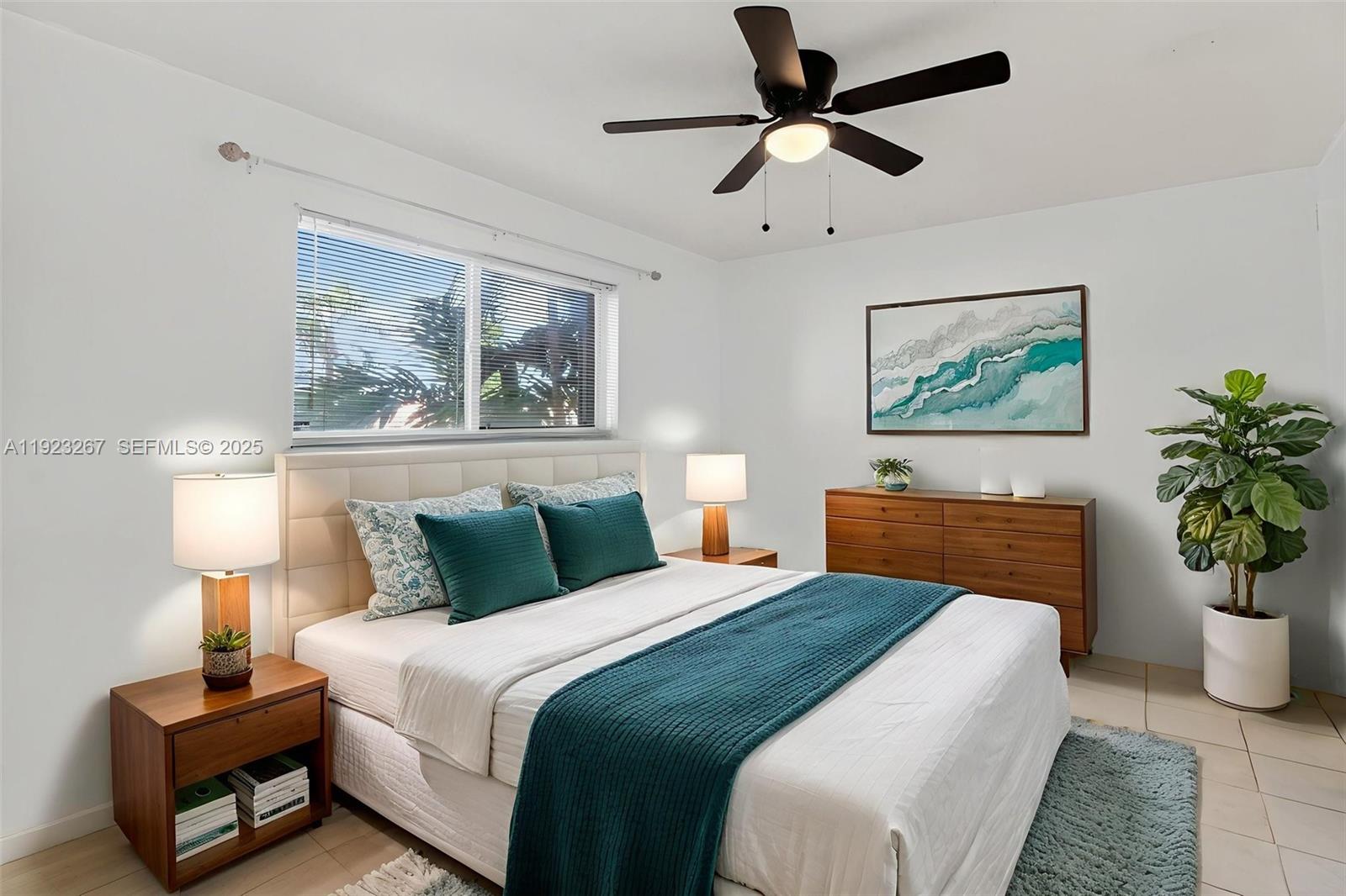 11309 Southwest 200th Street, Unit 209C Miami, FL 33157 - Photo 13 of 28 a bedroom with bed painting on the wall and a potted plant