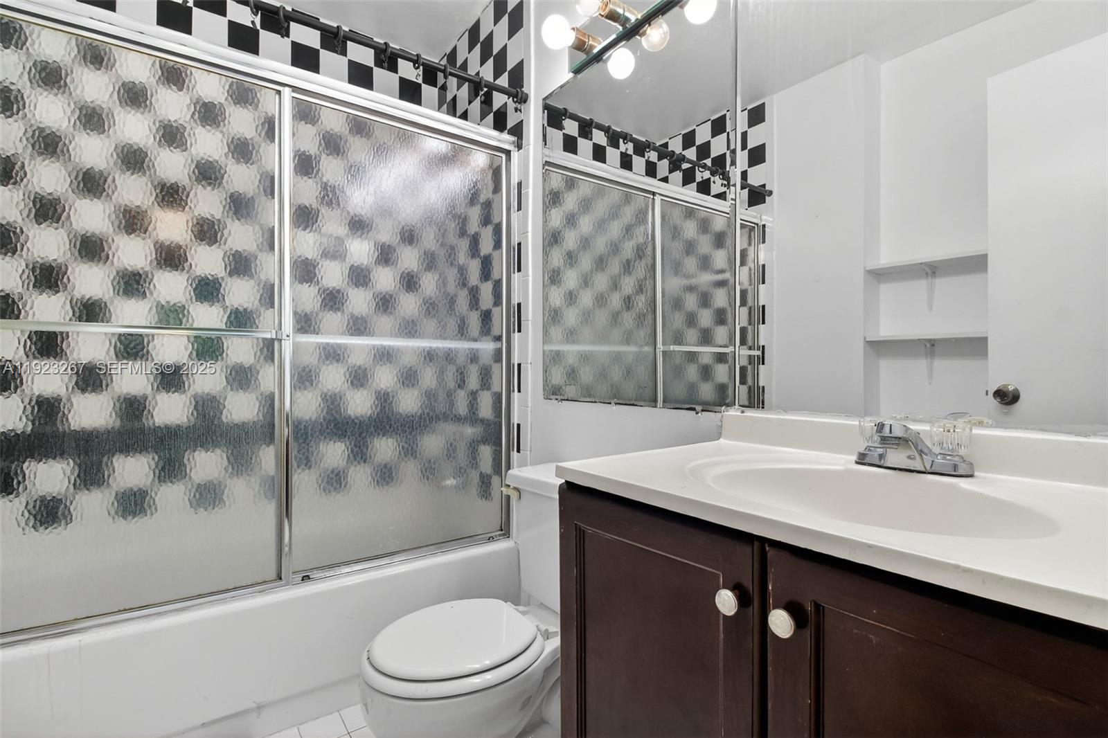 11309 Southwest 200th Street, Unit 209C Miami, FL 33157 - Photo 14 of 28 a bathroom with a sink toilet and shower