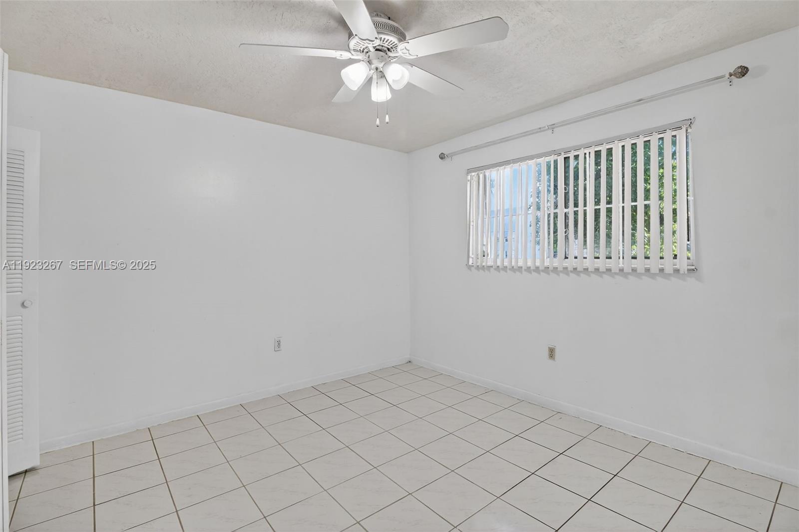 11309 Southwest 200th Street, Unit 209C Miami, FL 33157 - Photo 18 of 28 a view of an empty room with a window