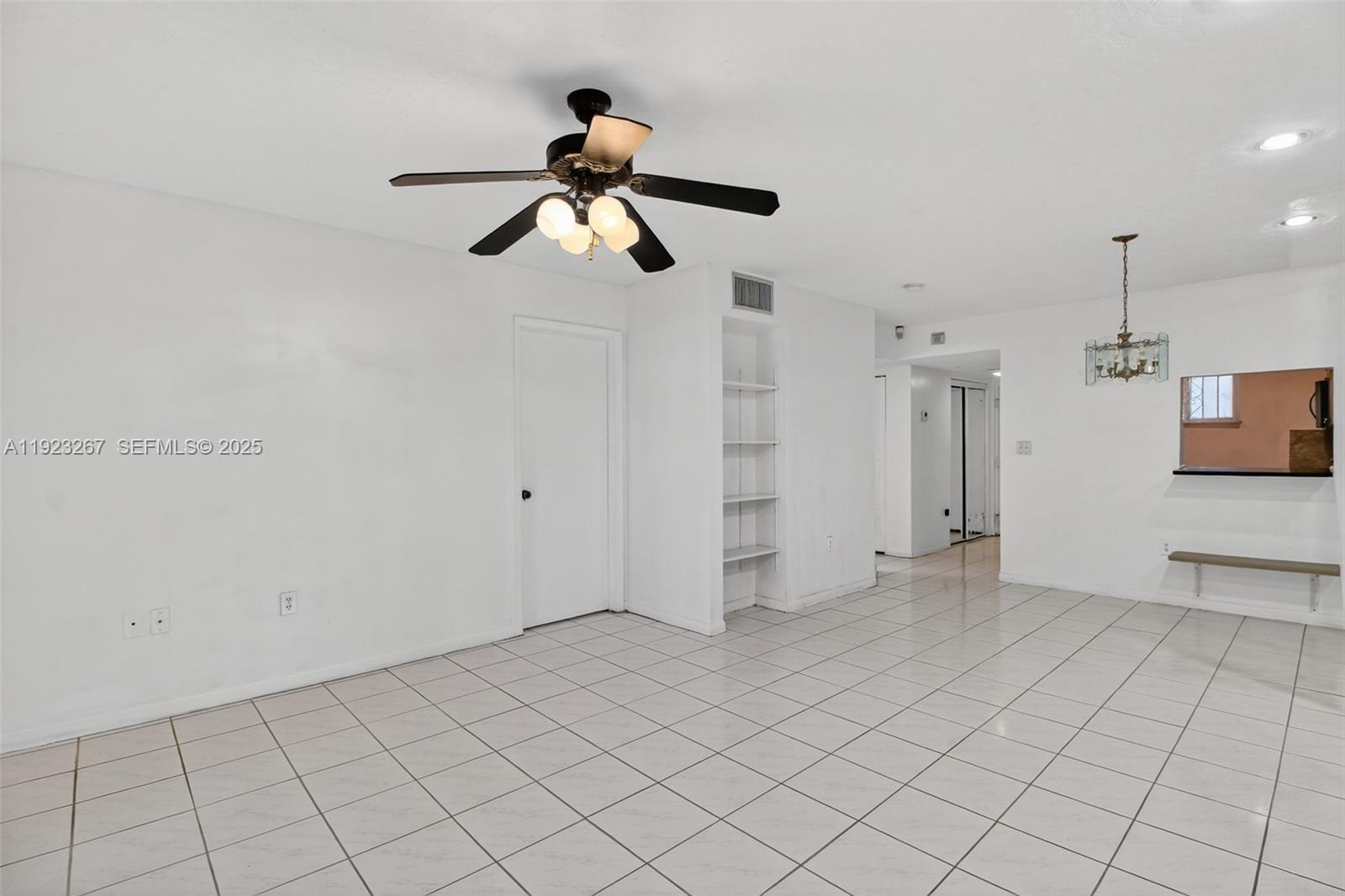 11309 Southwest 200th Street, Unit 209C Miami, FL 33157 - Photo 6 of 28 a view of a room with white walls and ceiling fan